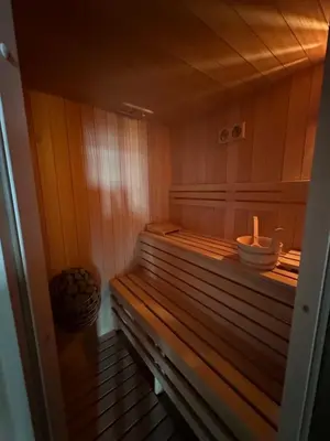 a sauna with a wooden bench in a room at Dom Na Brzegu in Limanowa