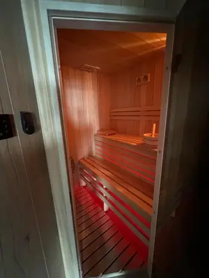 a small sauna with a wooden bench in a room at Dom Na Brzegu in Limanowa