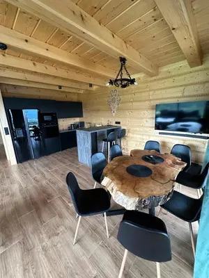 a dining room with a table and chairs at Dom Na Brzegu in Limanowa