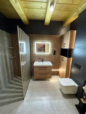 a bathroom with a sink and a toilet at Dom Na Brzegu in Limanowa