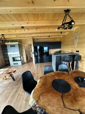 a room with a large wooden table and chairs at Dom Na Brzegu in Limanowa