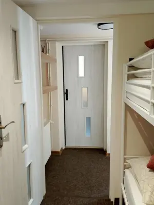 a room with a hallway with bunk beds and a door at Świerkowe zacisze 13km energylandia in Wożniki