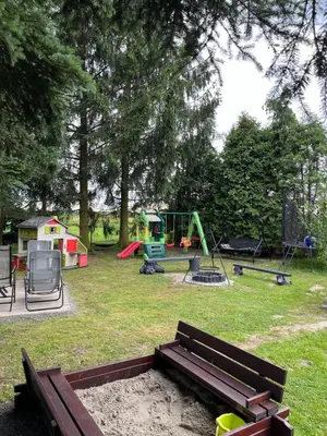 a park with a bench and a playground at Świerkowe zacisze 13km energylandia in Wożniki