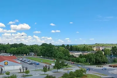 a parking lot with cars parked in a parking lot at Green apartament in Oświęcim