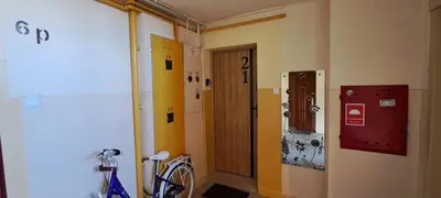 a room with a door and a bike on the wall at Green apartament in Oświęcim