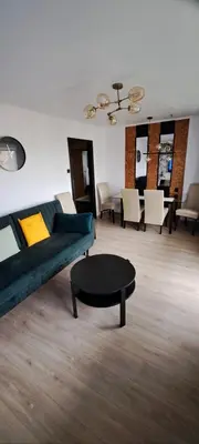 a living room with a couch and a coffee table at Green apartament in Oświęcim