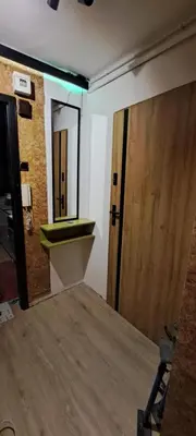 a room with a door and a sink and a mirror at Green apartament in Oświęcim