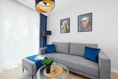 a living room with a couch and a table at Klimatyzowany Apartament w Centrum Krakowa z Parkingiem i Biurkiem by Renters Prestige in Kraków