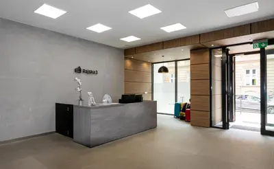 an office with a reception desk in a building at Rajska 3 Grey Apartment Krakow City in Kraków