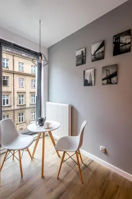 a dining room with a table and two chairs at Rajska 3 Grey Apartment Krakow City in Kraków