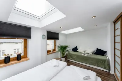 a bedroom with a bed and a window at Malila Premium Apartments Cracow City Center Grodzka 50 in Kraków