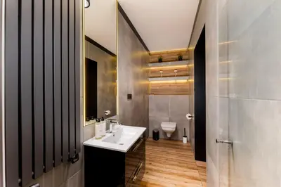 a bathroom with a sink and a toilet at Malila Premium Apartments Cracow City Center Grodzka 50 in Kraków