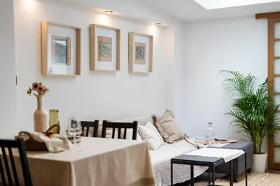 a living room with a table and a couch at Malila Premium Apartments Cracow City Center Grodzka 50 in Kraków