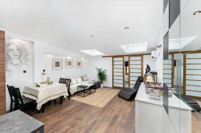 a living room with a table and a couch at Malila Premium Apartments Cracow City Center Grodzka 50 in Kraków