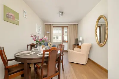 a kitchen and dining room with a table and chairs at Centrum Krakowa Piękny Apartament z Balkonem by Rent like home in Kraków