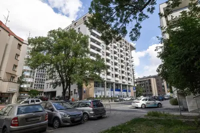 a parking lot with cars parked in front of a building at Centrum Krakowa Piękny Apartament z Balkonem by Rent like home in Kraków