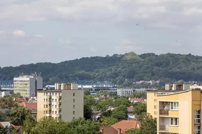 a city with buildings and a mountain in the background at Centrum Krakowa Piękny Apartament z Balkonem by Rent like home in Kraków