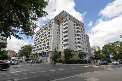 a large white building on the corner of a street at Centrum Krakowa Piękny Apartament z Balkonem by Rent like home in Kraków