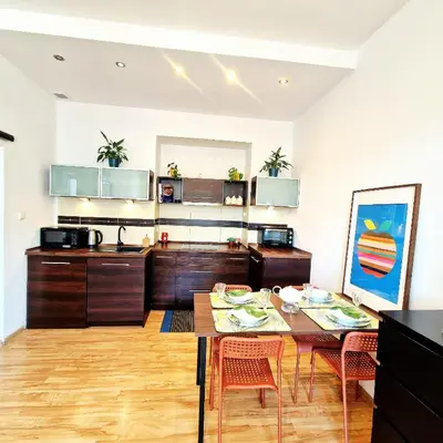 a kitchen and dining room with a table and chairs at Old Town Apartments - B6A in Kraków