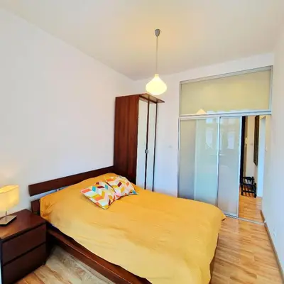 a bedroom with a bed with yellow sheets and a lamp at Old Town Apartments - B6A in Kraków