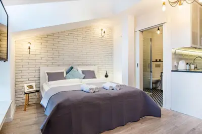 a bedroom with a large bed with two stuffed animals on it at Old Town Apartments - T36a in Kraków