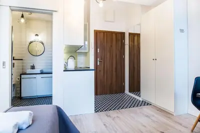 a room with a hallway with a kitchen and a door at Old Town Apartments - T36a in Kraków