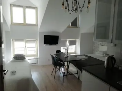a kitchen with a table and a dining room at Old Town Apartments - T36a in Kraków