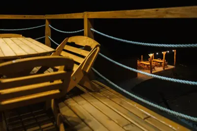 a bench and a table on the deck of a boat at Przystanek Modyń in Młyńczyska