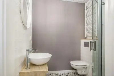 a bathroom with a white toilet and a sink at Old Town Apartments - T36b in Kraków