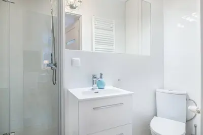 a bathroom with a toilet and a sink and a mirror at Old Town Apartments - T32 in Kraków