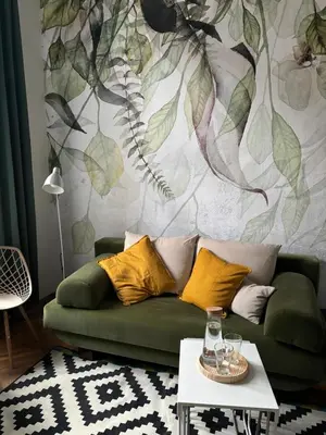 a living room with a green couch and a mural at Krakow Central Green Apartments in Kraków