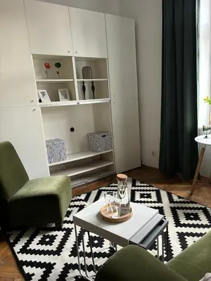 a living room with two chairs and a coffee table at Krakow Central Green Apartments in Kraków