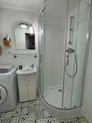 a bathroom with a shower and a toilet and a sink at Krakow Central Green Apartments in Kraków
