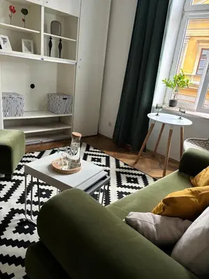 a living room with a green couch and a table at Krakow Central Green Apartments in Kraków