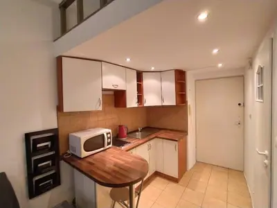 a kitchen with a microwave on a wooden table at Krakow Central Green Apartments in Kraków