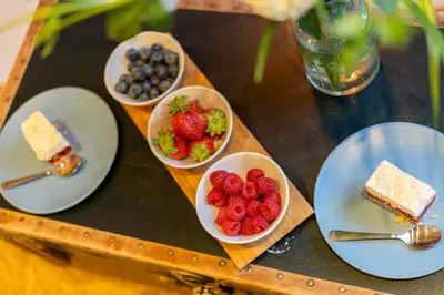 a table with plates of food and bowls of fruit at Lighthouse by Cozyplace in Kraków