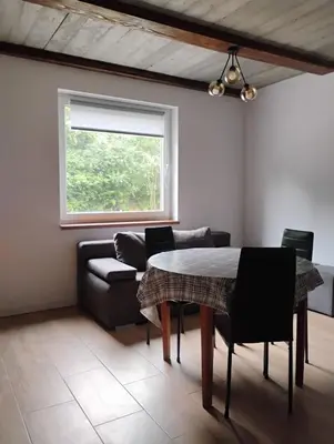 a living room with a table and a couch at Pokoje u Ewy in Limanowa