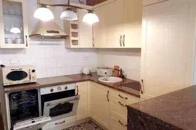 a kitchen with a sink and a stove top oven at Augustiańska Cozy Apartment A9 in Kraków