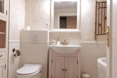 a bathroom with a sink and a toilet and a mirror at Augustiańska Cozy Apartment A9 in Kraków