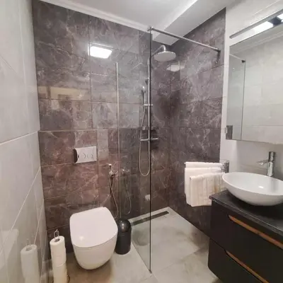 a bathroom with a shower and a toilet and a sink at Apartament Gotowizna in Wadowice