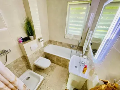 a kitchen with white cabinets and a glass table at Przytulne Apartamenciki tuż przy Termach i Parku, nieopodal szlak na Turbacz, GPN, KGP in Poręba Wielka