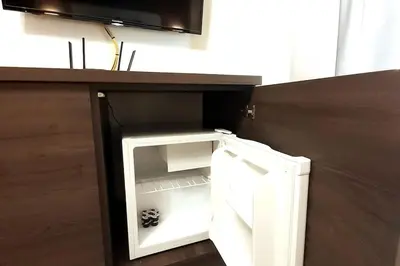 a small white refrigerator with its door open at Luxury Apartment - Rakowicka R15 in Kraków