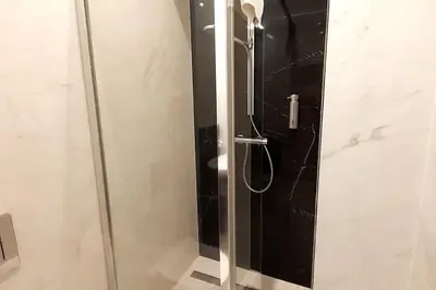 a shower with a glass door in a bathroom at Luxury Apartment - Rakowicka R15 in Kraków