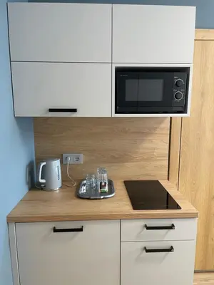 a kitchen with a counter top with a microwave at Rent Apartment in Wieliczka