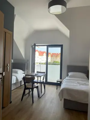 a bedroom with a bed and a table and chairs at Rent Apartment in Wieliczka