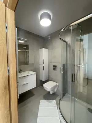 a bathroom with a shower and a toilet and a sink at Rent Apartment in Wieliczka