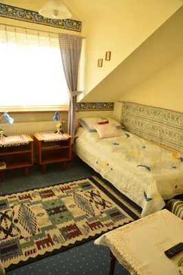 a bedroom with a large bed and a window at Pensjonat B&B Nad Rudawą in Kraków