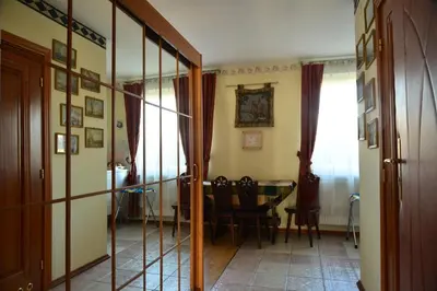 a hallway with a table and a dining room at Pensjonat B&B Nad Rudawą in Kraków