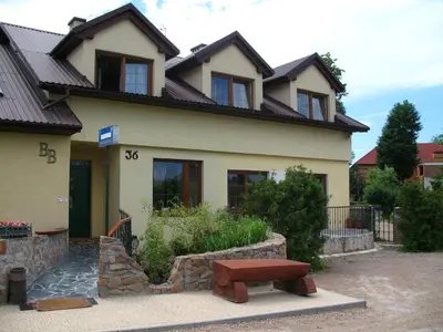a house with a bench in front of it at Pensjonat B&B Nad Rudawą in Kraków