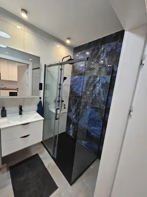 a bathroom with a shower and a sink at Apartament Centralna Park in Kraków